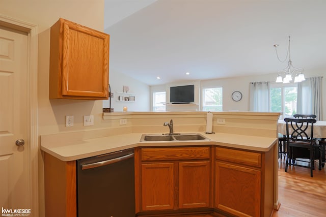 56798 Winding Creek Dr, Macomb, MI 48042 - kitchen with dishwasher, a peninsula, light countertops, light wood-style floors, and a chandelier