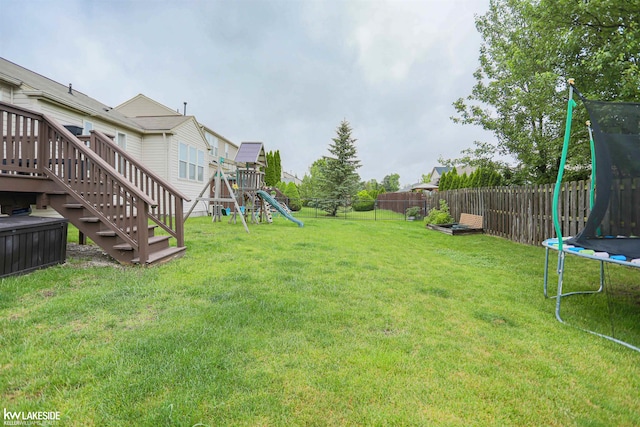 56798 Winding Creek Dr, Macomb, MI 48042 - fenced backyard featuring a trampoline, a playground, a wooden deck, and stairs