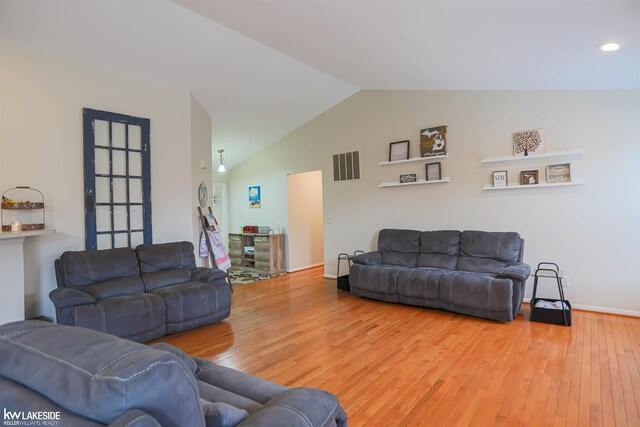 56798 Winding Creek Dr, Macomb, MI 48042 - living area with wood finished floors, vaulted ceiling, and recessed lighting