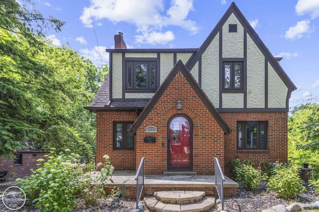 35727 Elm St, Wayne, MI 48184 - tudor-style house with brick siding, a chimney, and stucco siding