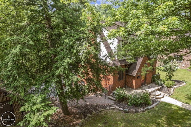 35727 Elm St, Wayne, MI 48184 - view of side of home featuring brick siding, a yard, and a shingled roof