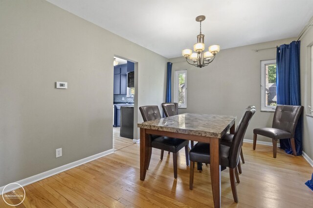35727 Elm St, Wayne, MI 48184 - dining area with a chandelier and light wood-type flooring