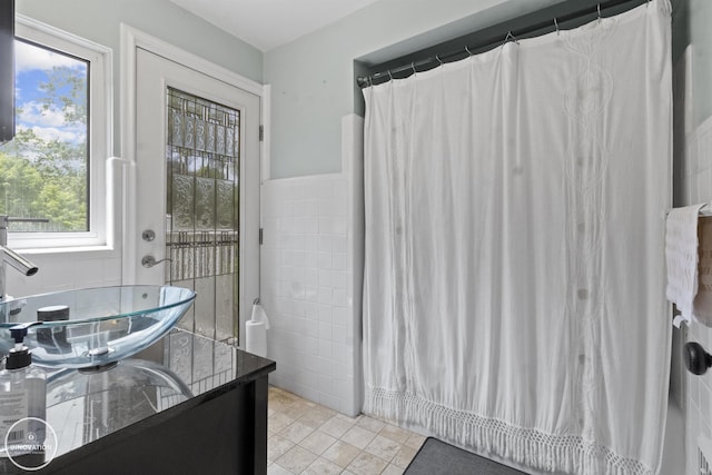 35727 Elm St, Wayne, MI 48184 - bathroom with vanity, healthy amount of natural light, tile walls, tile patterned floors, and a shower with shower curtain