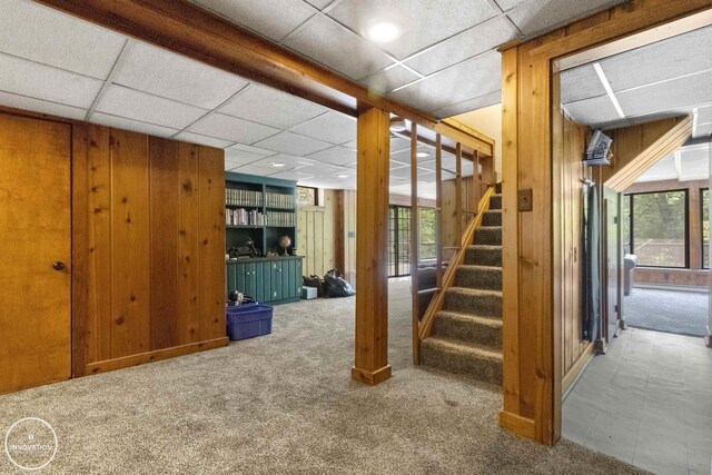 35727 Elm St, Wayne, MI 48184 - basement with carpet flooring, wooden walls, stairway, and a drop ceiling