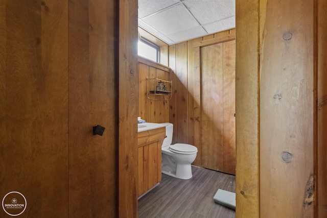 35727 Elm St, Wayne, MI 48184 - bathroom with vanity, wood finished floors, a drop ceiling, and wooden walls