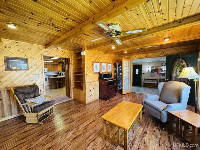 292 Chestnut St, Kingsford, MI 49802 - living area with wood finished floors, wooden walls, ceiling fan, and a wood ceiling with exposed beams