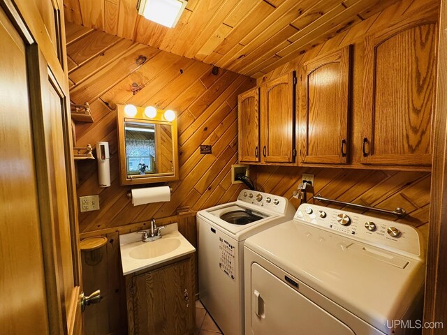 292 Chestnut St, Kingsford, MI 49802 - washroom with washing machine and dryer, cabinet space, wood ceiling, and wooden walls