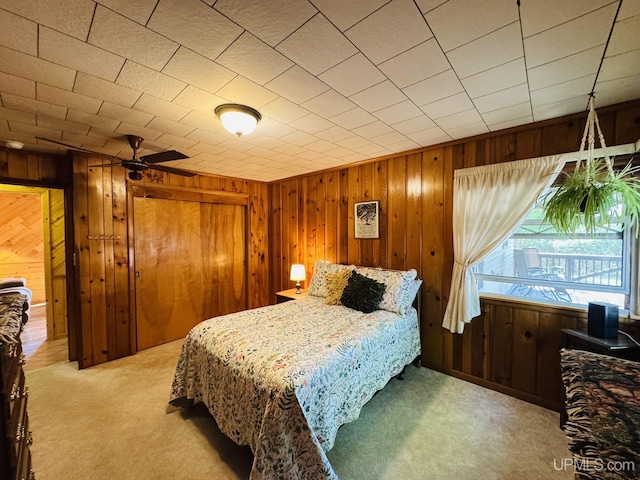 292 Chestnut St, Kingsford, MI 49802 - carpeted bedroom featuring wooden walls and a closet