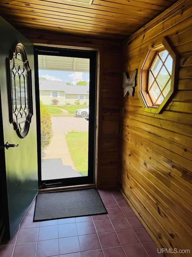 292 Chestnut St, Kingsford, MI 49802 - doorway to outside featuring wooden ceiling, wood walls, and dark tile patterned flooring