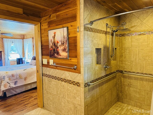 292 Chestnut St, Kingsford, MI 49802 - bathroom featuring a stall shower, connected bathroom, wood ceiling, a ceiling fan, and wood walls