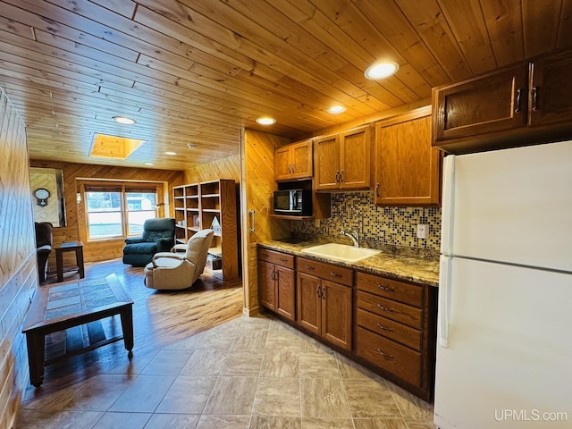 292 Chestnut St, Kingsford, MI 49802 - kitchen featuring freestanding refrigerator, black microwave, wooden ceiling, wood walls, and recessed lighting