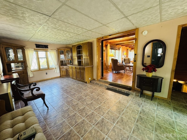 292 Chestnut St, Kingsford, MI 49802 - living room with a paneled ceiling and baseboards