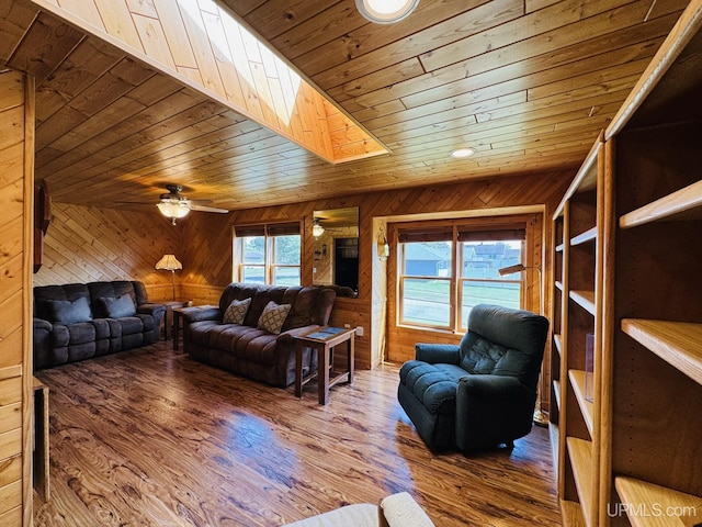 292 Chestnut St, Kingsford, MI 49802 - living room with wood ceiling, wooden walls, a ceiling fan, wood finished floors, and a skylight