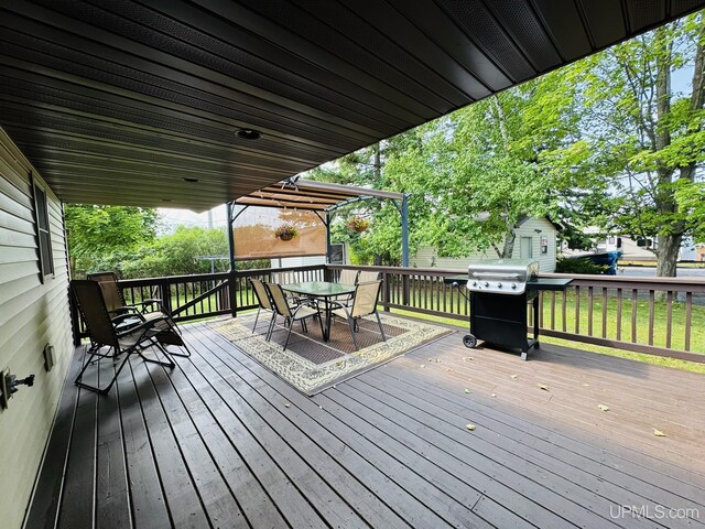 292 Chestnut St, Kingsford, MI 49802 - wooden terrace with outdoor dining area and a grill