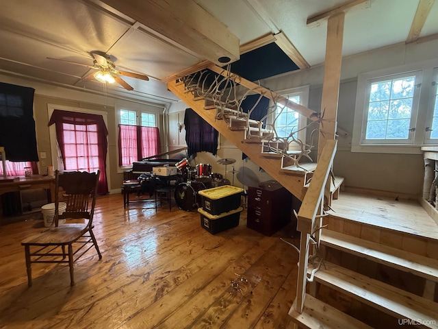 E2903 H44 Rd, Traunik, MI 49891 - living room with stairs, hardwood / wood-style floors, plenty of natural light, and a ceiling fan