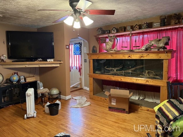 E2903 H44 Rd, Traunik, MI 49891 - bedroom with a textured ceiling, wood finished floors, and a ceiling fan
