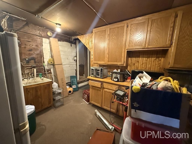 E2903 H44 Rd, Traunik, MI 49891 - kitchen with light countertops, concrete block wall, and carpet flooring