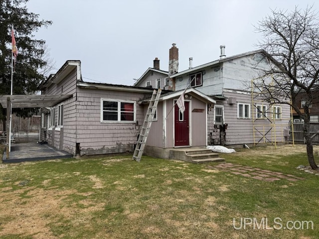E2903 H44 Rd, Traunik, MI 49891 - rear view of property with a pergola, a chimney, and entry steps
