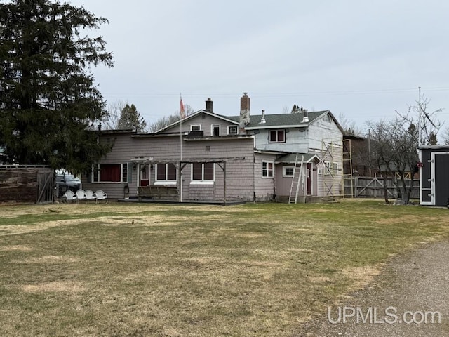 E2903 H44 Rd, Traunik, MI 49891 - rear view of house featuring a chimney and a shed