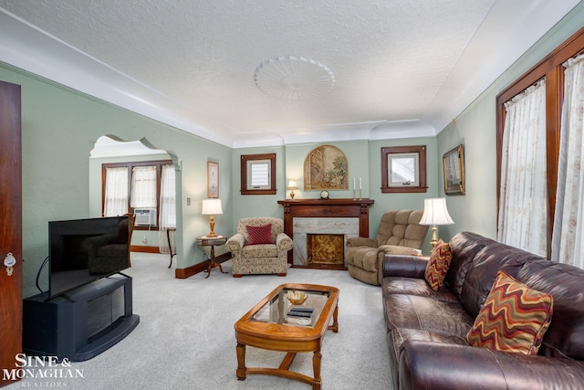 1258-1260 Lakepointe St, Grosse Pointe, MI 48230 - living area featuring arched walkways, carpet, a premium fireplace, cooling unit, and a textured ceiling