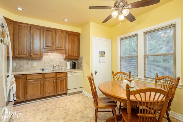 1258-1260 Lakepointe St, Grosse Pointe, MI 48230 - kitchen with dishwasher, light countertops, tasteful backsplash, brown cabinets, and range