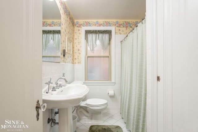 1258-1260 Lakepointe St, Grosse Pointe, MI 48230 - bathroom with tile patterned floors, tile walls, wallpapered walls, a shower with curtain, and a wainscoted wall