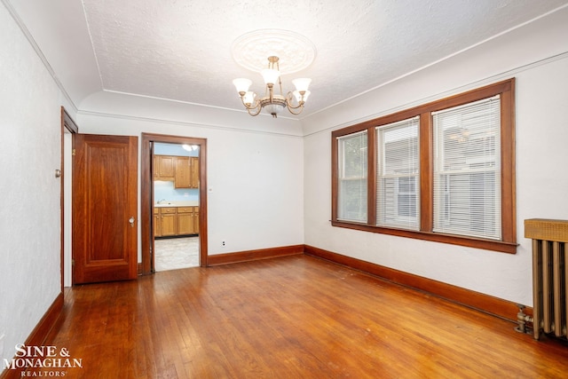 1258-1260 Lakepointe St, Grosse Pointe, MI 48230 - unfurnished room featuring hardwood / wood-style flooring, a chandelier, radiator heating unit, and a textured ceiling