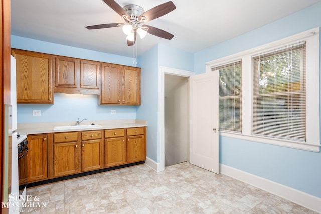 1258-1260 Lakepointe St, Grosse Pointe, MI 48230 - kitchen with black stove, brown cabinetry, light countertops, and ceiling fan