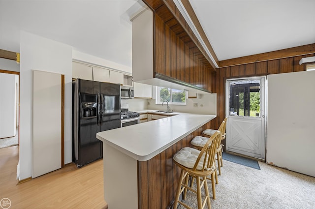 28368 Besmore Dr, Warren, MI 48093 - kitchen featuring stainless steel appliances, a peninsula, a kitchen breakfast bar, light countertops, and white cabinets