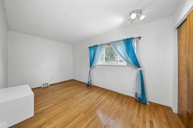 28368 Besmore Dr, Warren, MI 48093 - unfurnished bedroom with light wood-style flooring and a closet