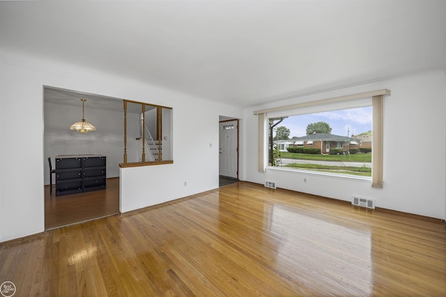 28368 Besmore Dr, Warren, MI 48093 - empty room featuring stairs and wood finished floors