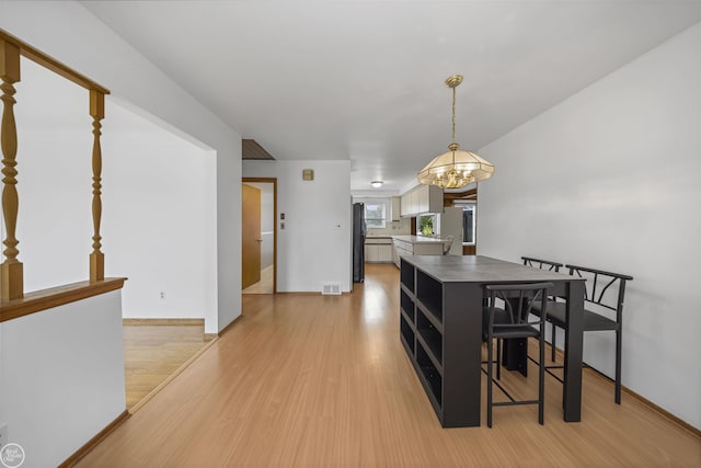 28368 Besmore Dr, Warren, MI 48093 - dining space featuring light wood-style flooring and a chandelier