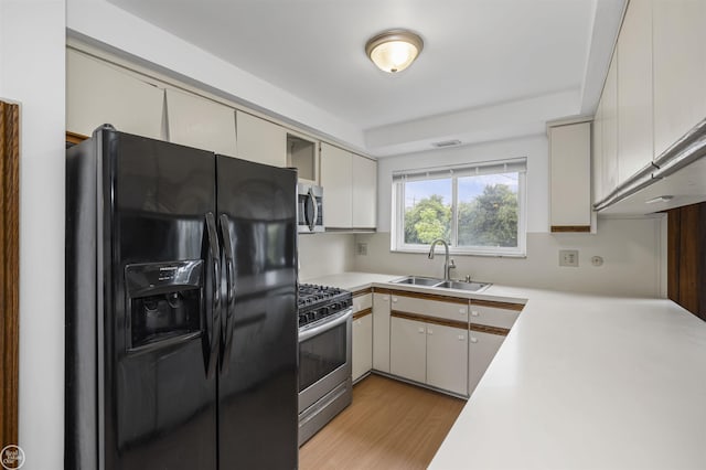28368 Besmore Dr, Warren, MI 48093 - kitchen with appliances with stainless steel finishes, light countertops, and light wood finished floors