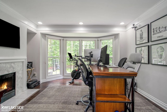 25986 Glenmoor St, Novi, MI 48374 - home office with crown molding, wood finished floors, a tiled fireplace, and recessed lighting