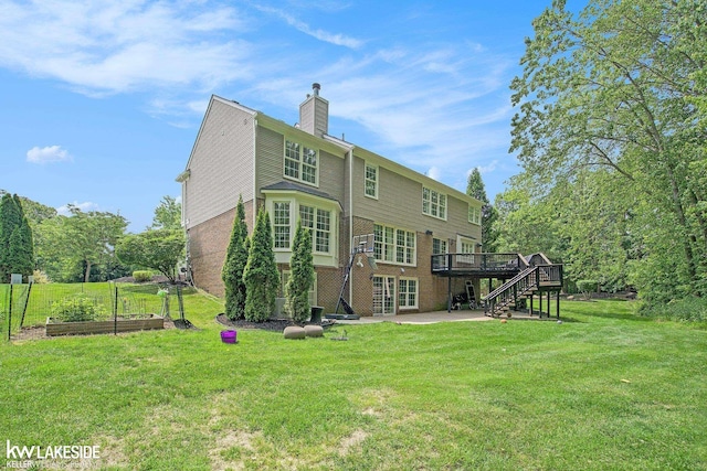 25986 Glenmoor St, Novi, MI 48374 - rear view of house featuring a garden, a deck, a patio area, a chimney, and stairs