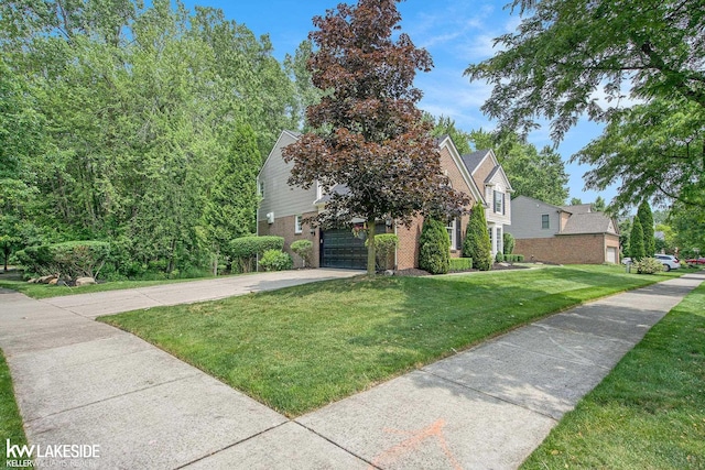 25986 Glenmoor St, Novi, MI 48374 - obstructed view of property featuring brick siding, driveway, and a front yard