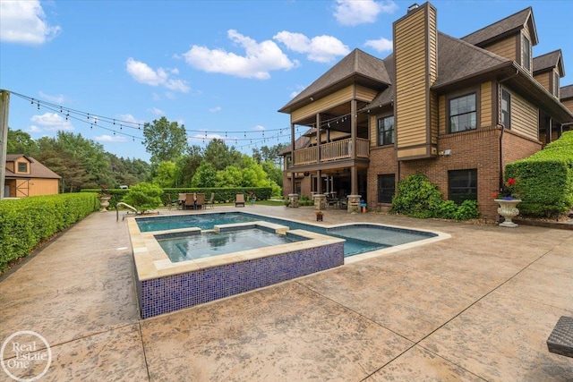 2940 Buell Rd, Oakland Twp, MI 48363 - view of swimming pool featuring a patio area and a pool with connected hot tub