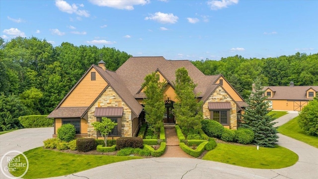 2940 Buell Rd, Oakland Twp, MI 48363 - view of front of home featuring stone siding, a standing seam roof, a shingled roof, a metal roof, and a front lawn