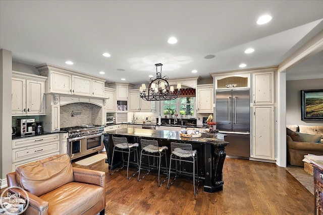 2940 Buell Rd, Oakland Twp, MI 48363 - kitchen featuring high quality appliances, dark countertops, a breakfast bar area, dark wood finished floors, and recessed lighting