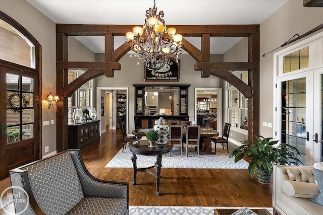 2940 Buell Rd, Oakland Twp, MI 48363 - living room featuring wood finished floors, a chandelier, french doors, and high vaulted ceiling