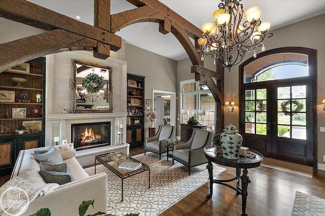 2940 Buell Rd, Oakland Twp, MI 48363 - living area featuring french doors, arched walkways, wood finished floors, a fireplace, and built in features