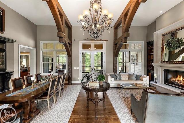 2940 Buell Rd, Oakland Twp, MI 48363 - living room with healthy amount of natural light, french doors, a warm lit fireplace, a chandelier, and a high ceiling