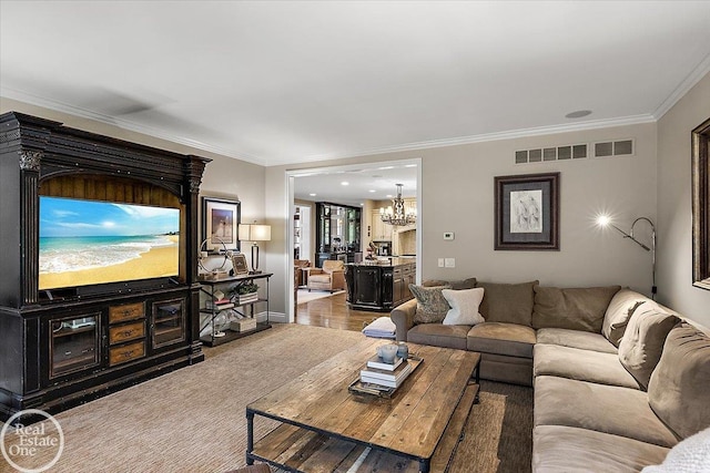 2940 Buell Rd, Oakland Twp, MI 48363 - living area with ornamental molding, a chandelier, and wood finished floors