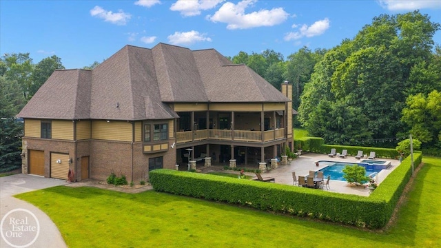 2940 Buell Rd, Oakland Twp, MI 48363 - back of property featuring a garage, a lawn, a chimney, and brick siding