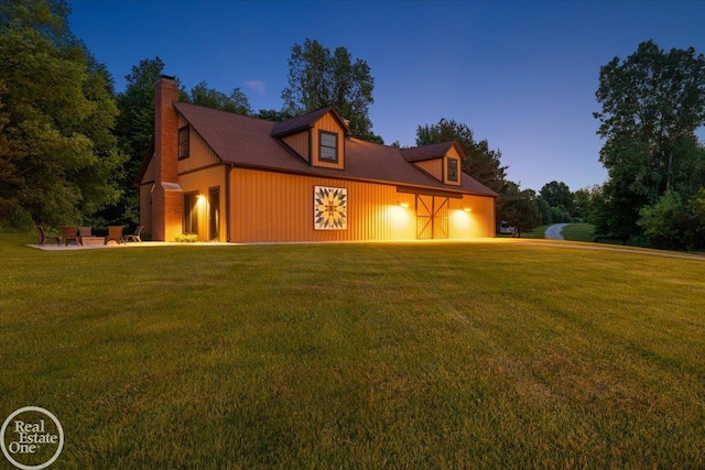 2940 Buell Rd, Oakland Twp, MI 48363 - view of front of house with a garage, a front lawn, a chimney, and driveway