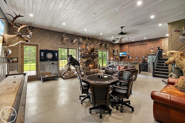 2940 Buell Rd, Oakland Twp, MI 48363 - dining room with recessed lighting, a ceiling fan, finished concrete flooring, wood walls, and stairway