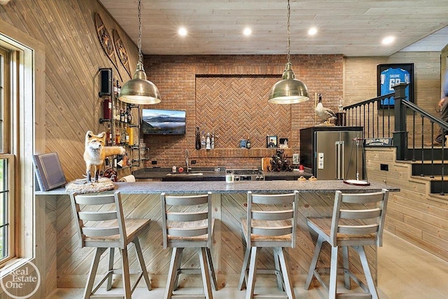 2940 Buell Rd, Oakland Twp, MI 48363 - indoor bar with high end fridge, wooden walls, and decorative light fixtures