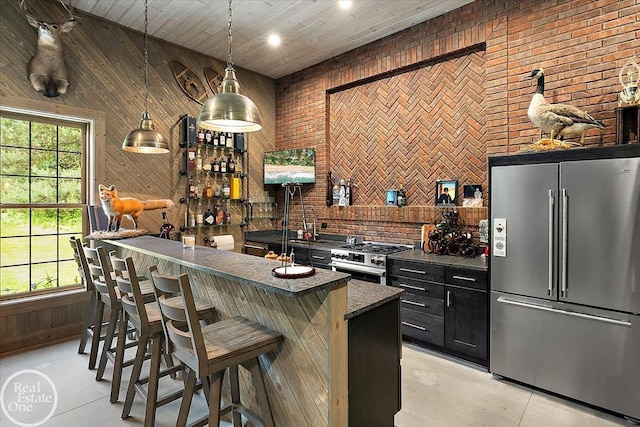 2940 Buell Rd, Oakland Twp, MI 48363 - indoor bar featuring high end appliances, wood walls, pendant lighting, and concrete floors