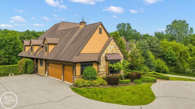 2940 Buell Rd, Oakland Twp, MI 48363 - view of front of home featuring asphalt driveway, a front yard, stone siding, roof with shingles, and a chimney