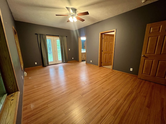 876 N Sanford Ln, Au Gres, MI 48703 - spare room featuring ceiling fan, light wood-style floors, and a textured ceiling